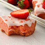 close up of a strawberry blondie on a white tablecloth