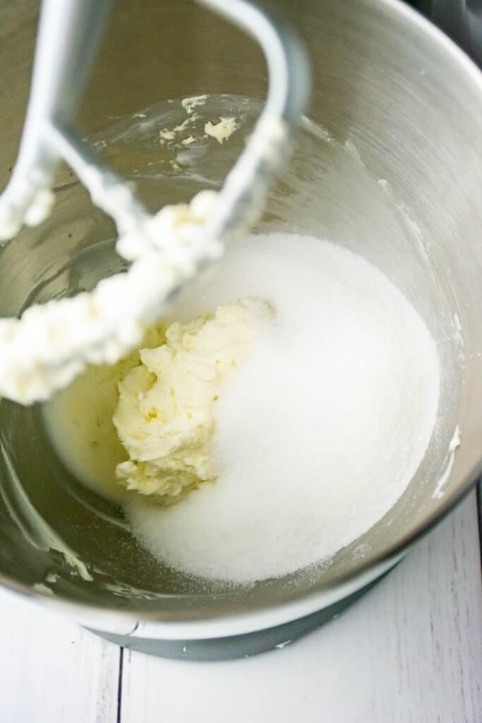 butter and sugar in a stainless steel mixing bowl