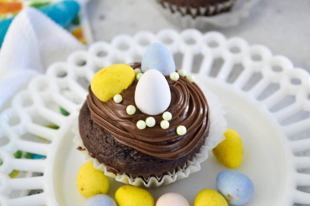 birds eye image of chocolate mini egg cupcakes on a white plate