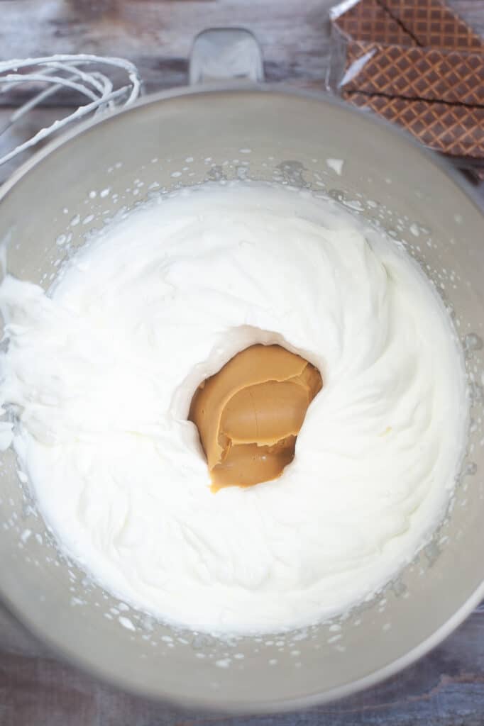 whipped heavy whipping cream and peanut butter in a stainless steel bowl