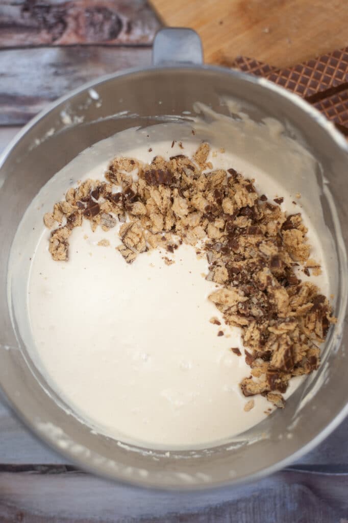 chopped nutty buddy wafers being added to ice cream mixture