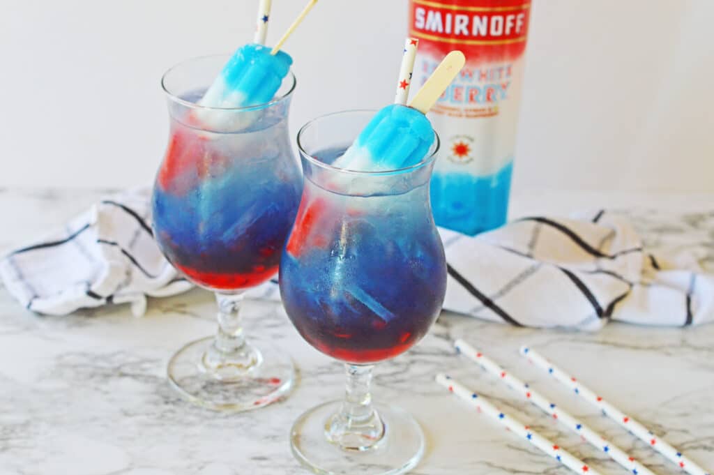 two glasses of bomb pop cocktails on marble counter