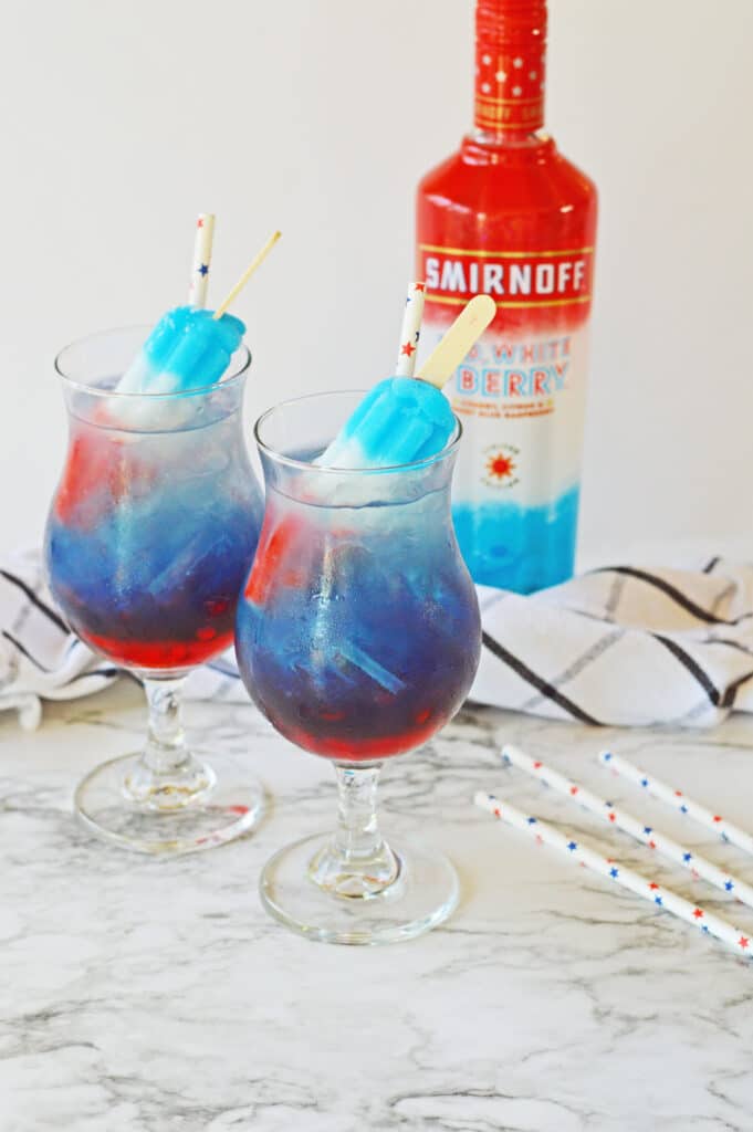 two glasses of bomb pop cocktails on marble counter