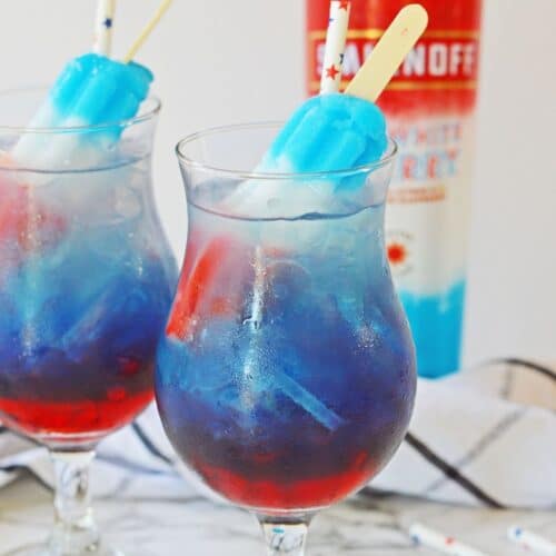 two glasses of bomb pop cocktail on a marble counter
