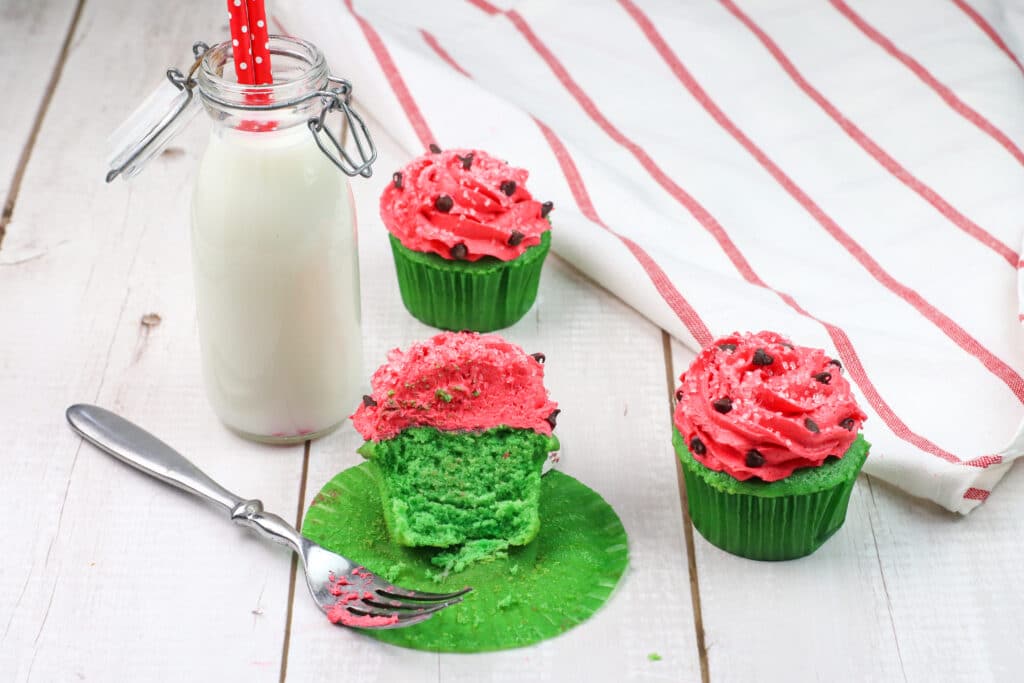 Watermelon cupcake cut in half on a wooden background