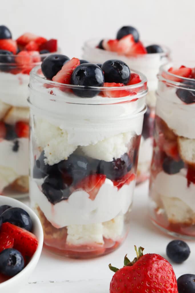 close up of a summer berry trifle in a mason jar