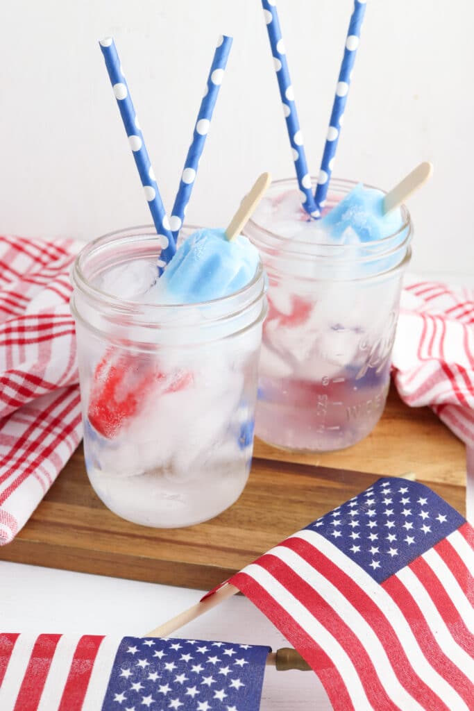 Bomb Pops Mocktails on a wooden cutting board