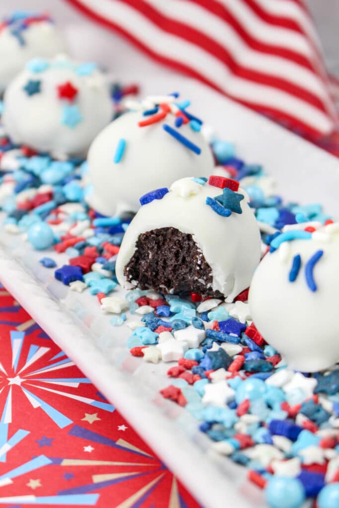 close up of the inside of a patriotic oreo balls on a white platter