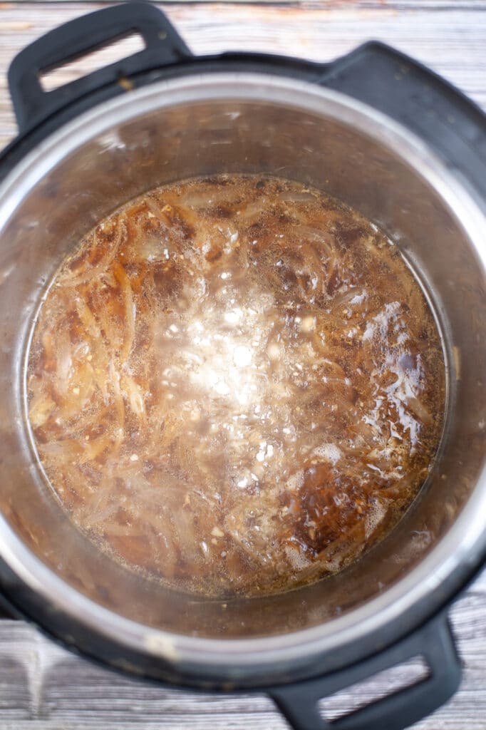 flour be adding to a onions and beef broth in a pressure cooker