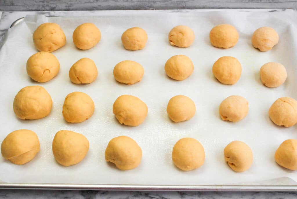 sweet potato roll dough on a parchment lined baked sheet