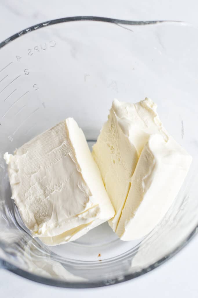 cream cheese blocks in a glass mixing bowl