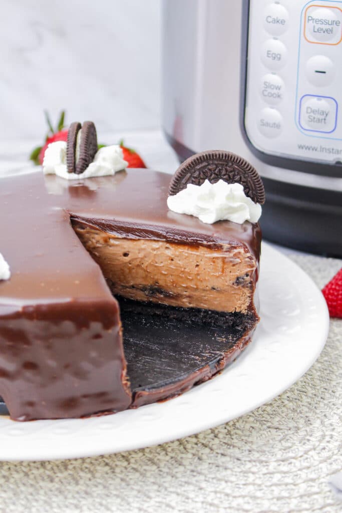 whole Instant Pot Oreo Nutella cheesecake with a slice missing