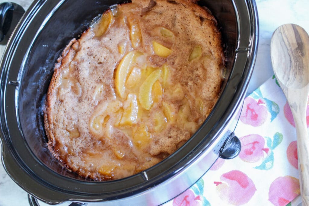 finished peach cobbler cooked in the slow cooker