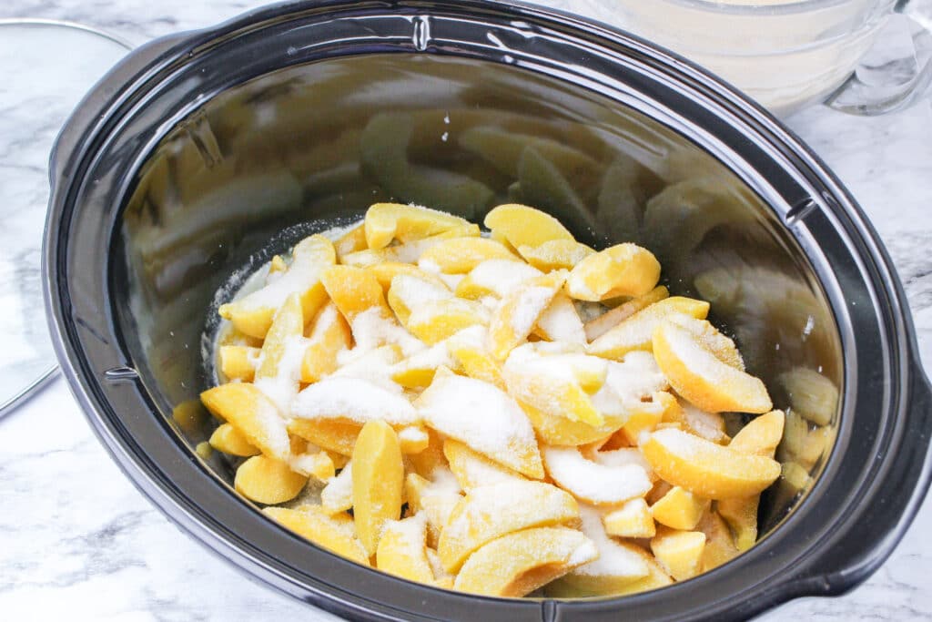 peach and sugar in a slow cooker liner