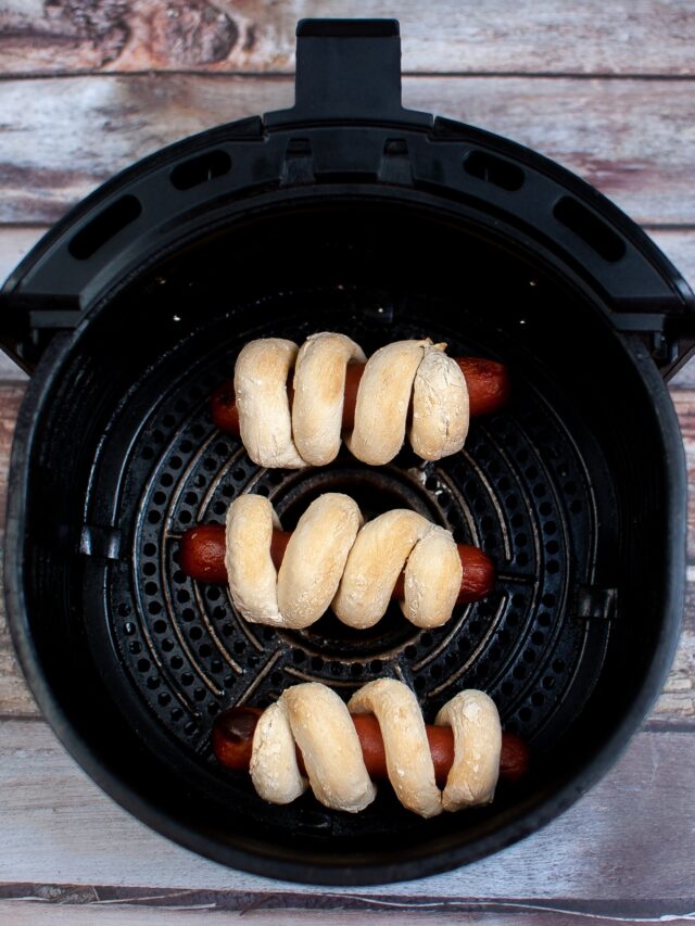 cooked air fryer pretzel dogs in air fryer basket