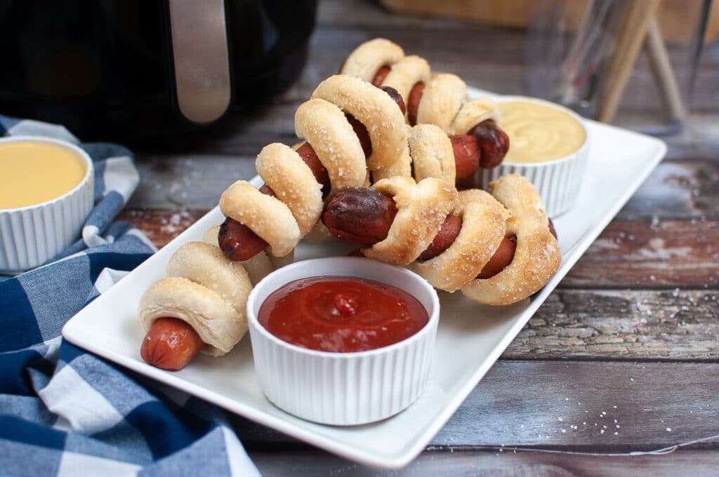 air fryer pretzel dogs on a white plate