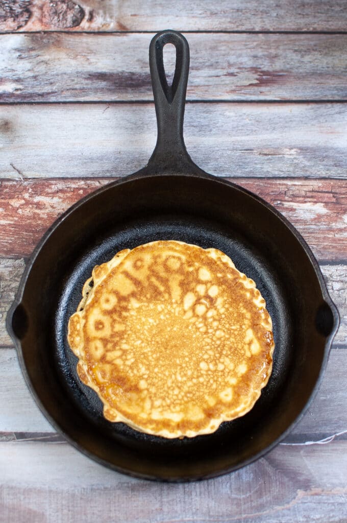 finished sourdough discard pancake in a cast iron skillet