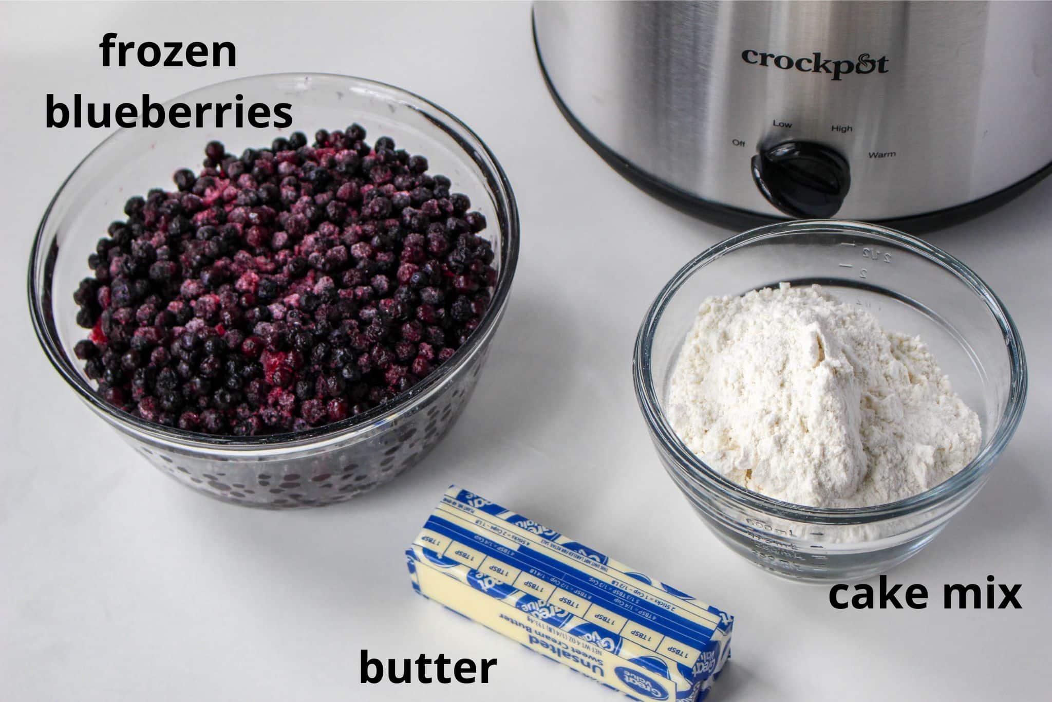 ingredients for slow cooker blueberry cobbler labelled with text 