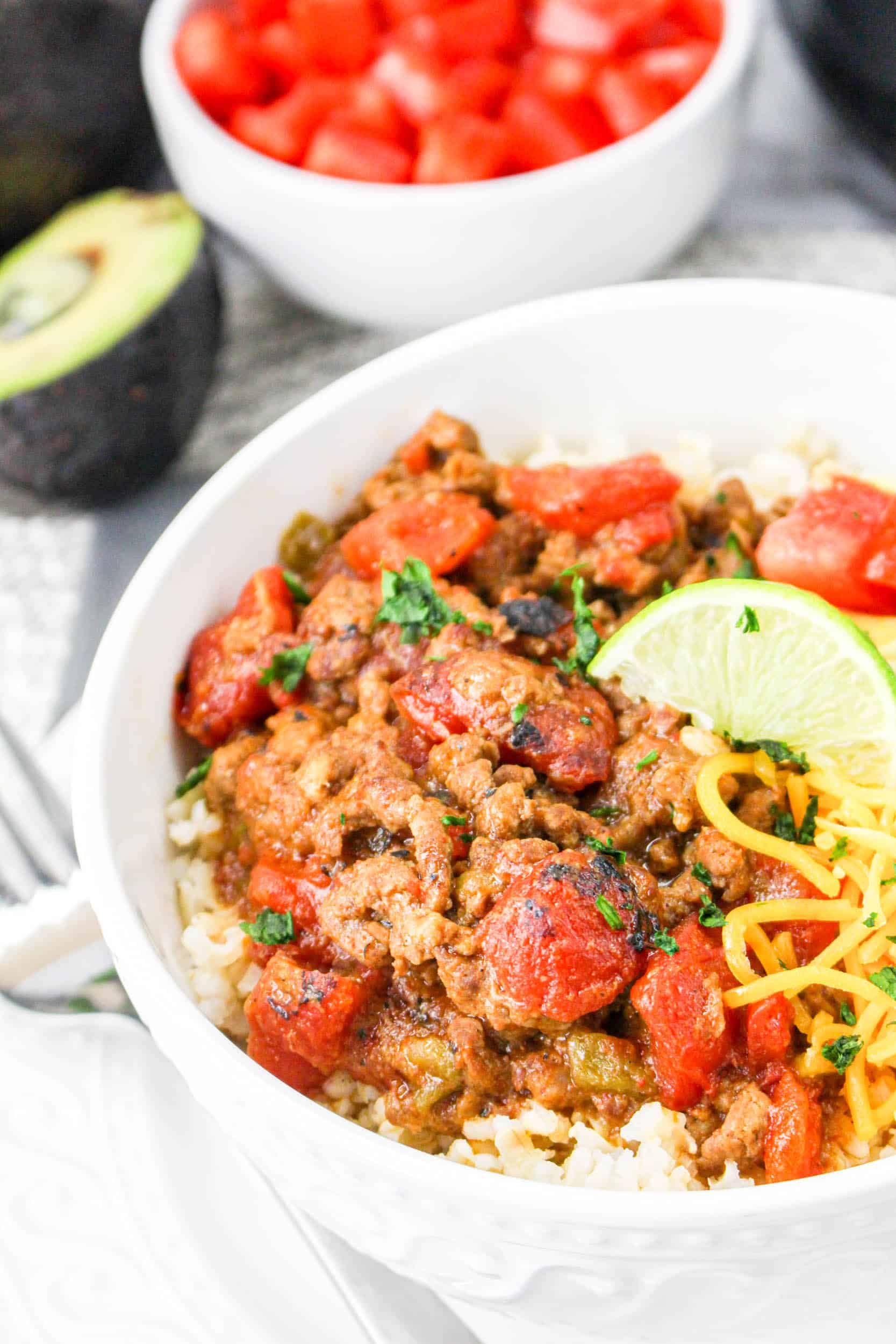Slow Cooker Carne Picada in a white bowl filled with rice
