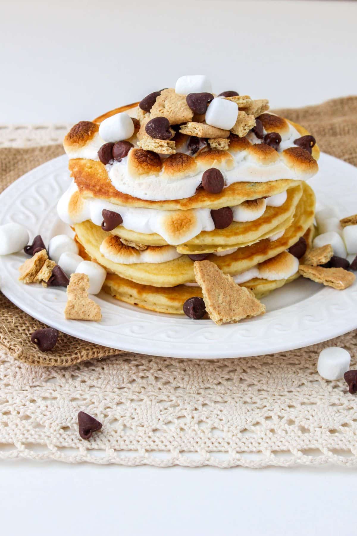 stack of smores pancakes on a white plate