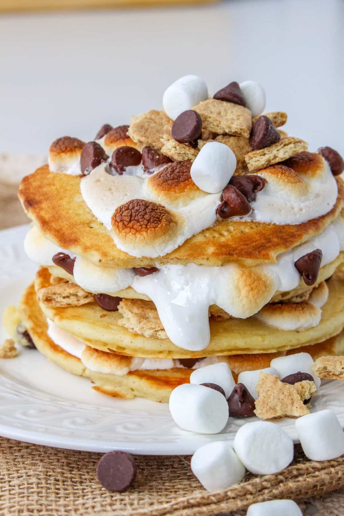 stack of smores pancakes on a white plate