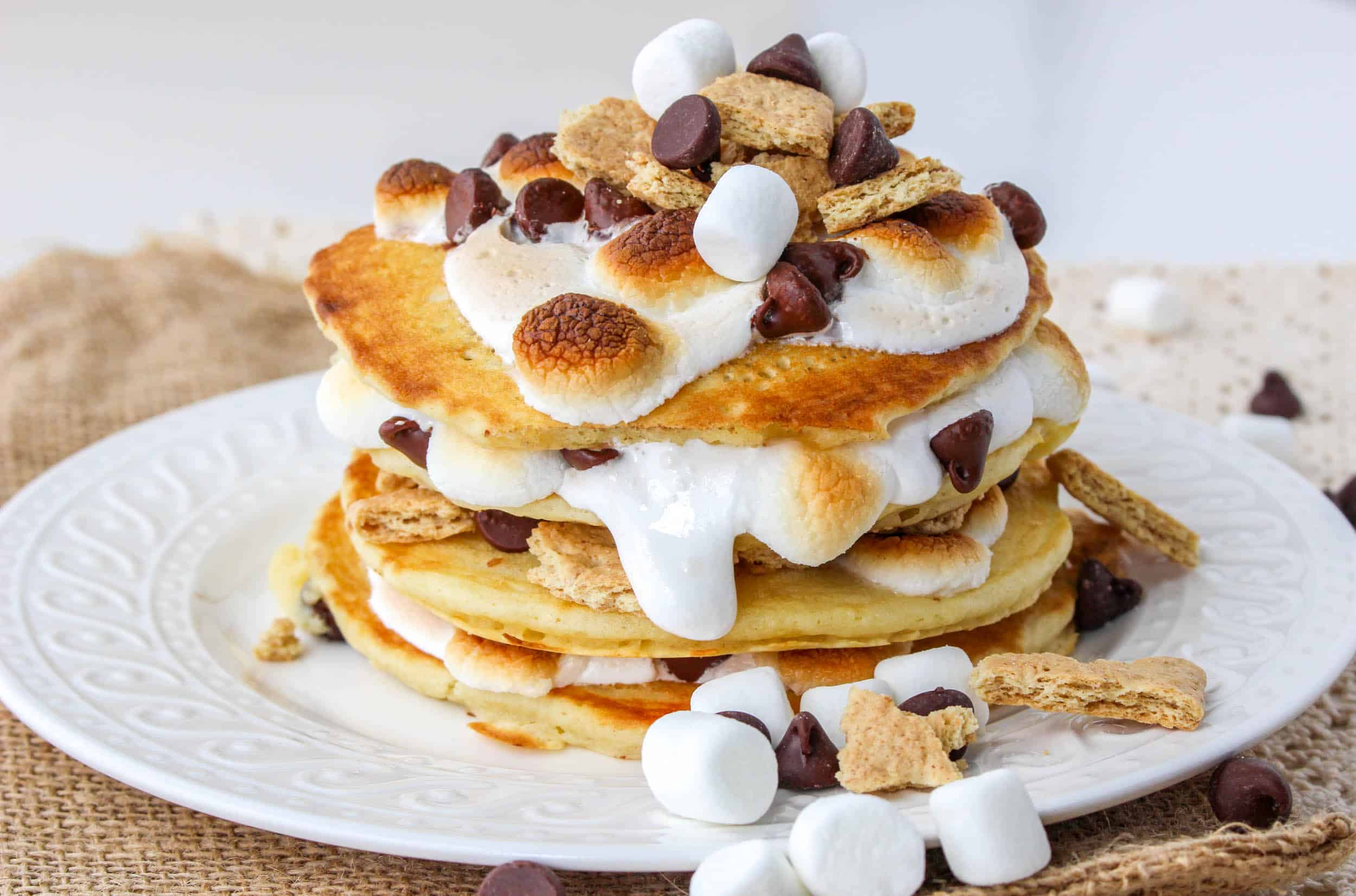 finished stack of smores pancakes on a white plate
