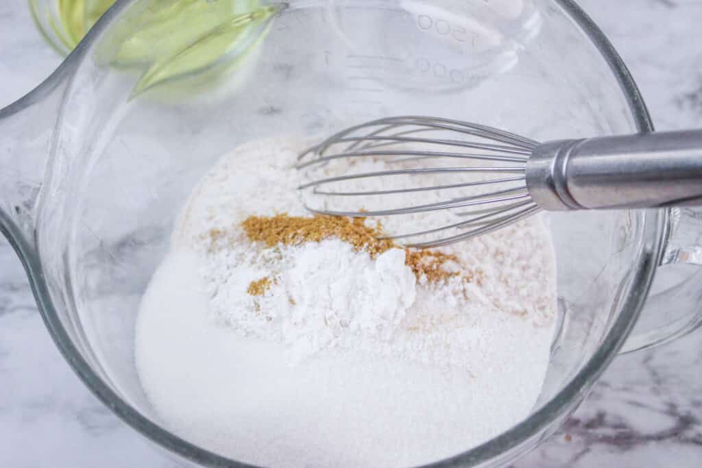 flour, sugar, cinnamon and salt in a glass mixing bowl with a whisk