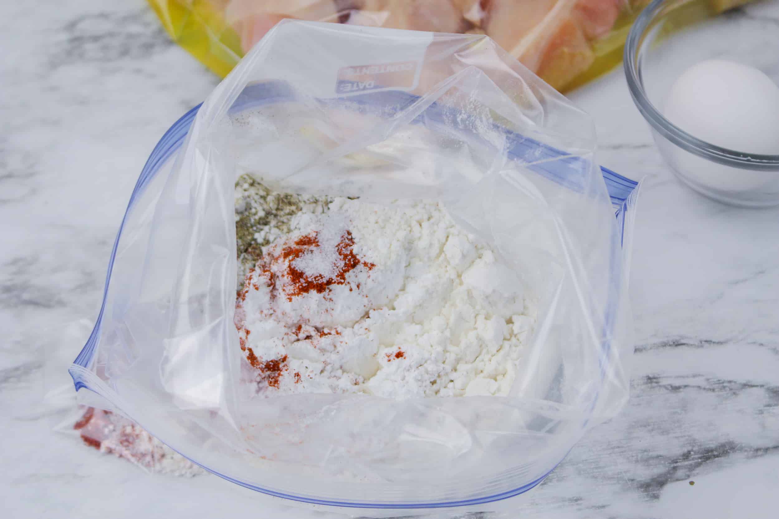 flour and seasoning in a gallon sized storage bags