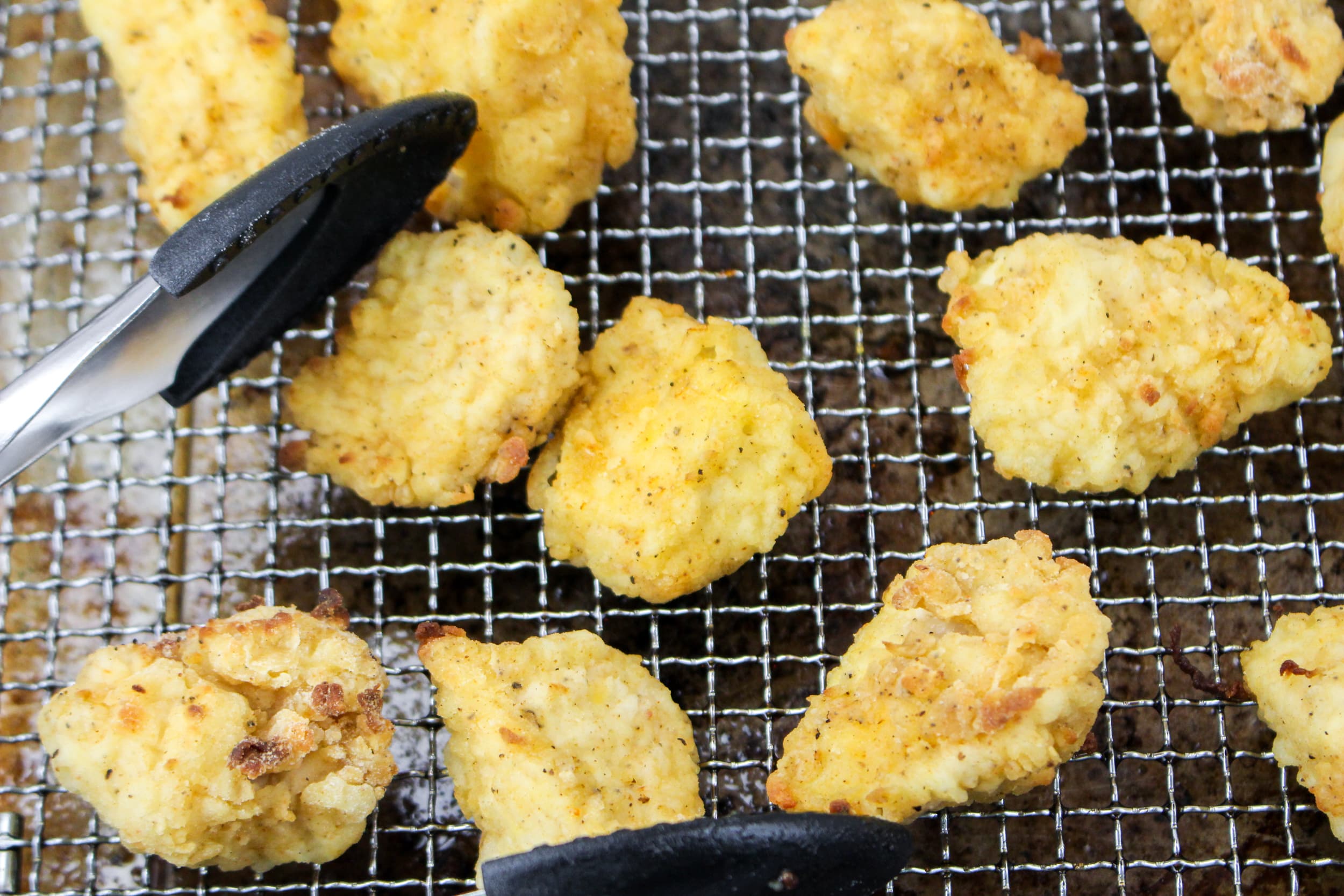 cooked chicken nuggets on an air fryer basket