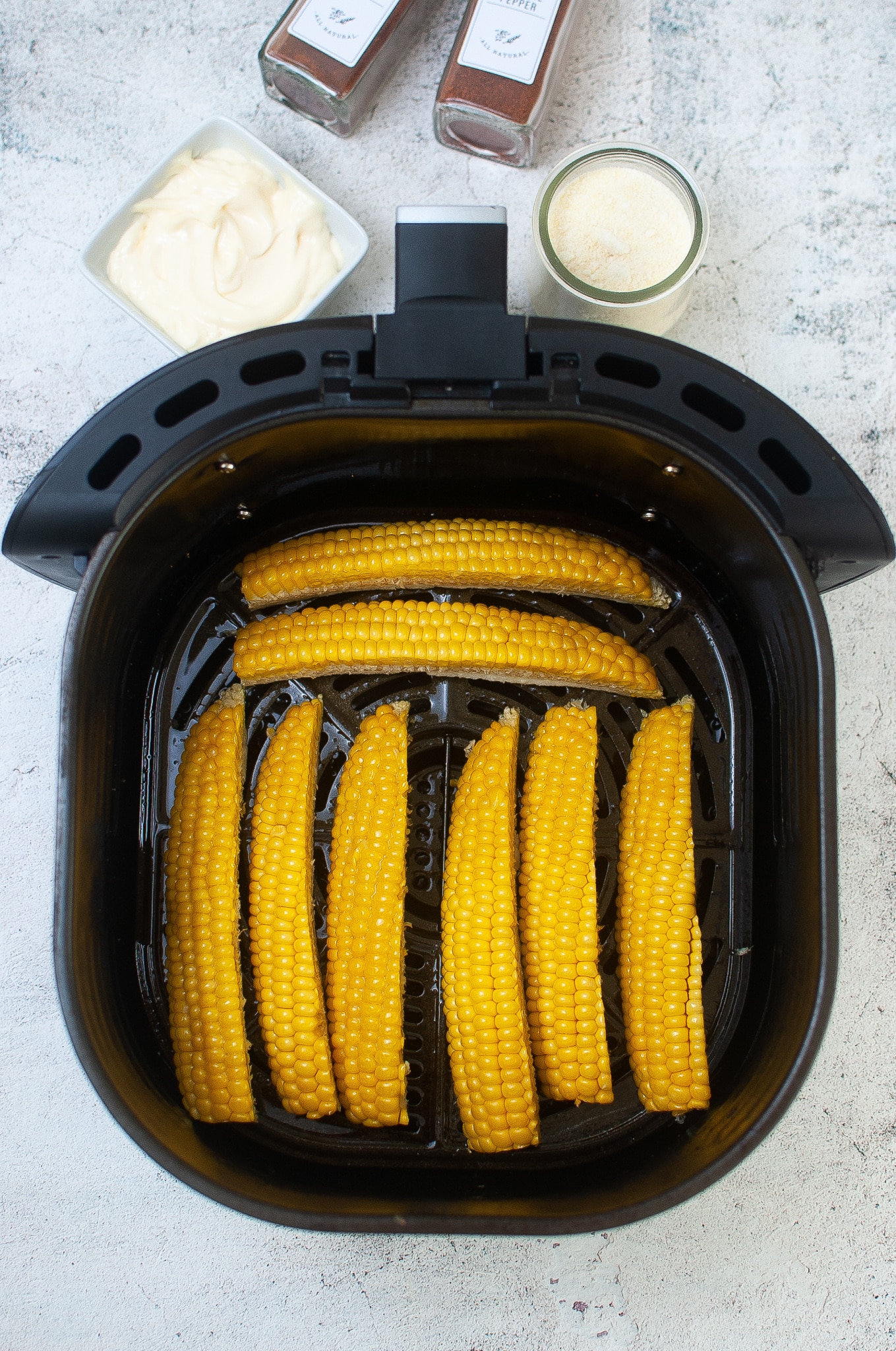 ribs spread out in an air fryer basket