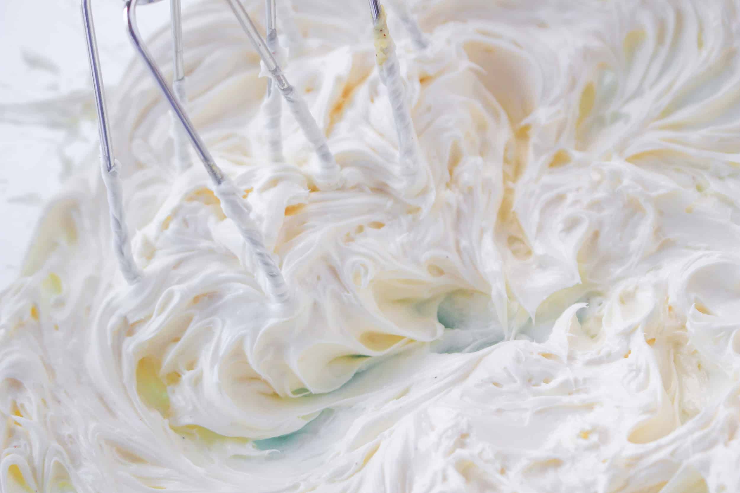 cream cheese whipping until it is fluff in a glass mixing bowl