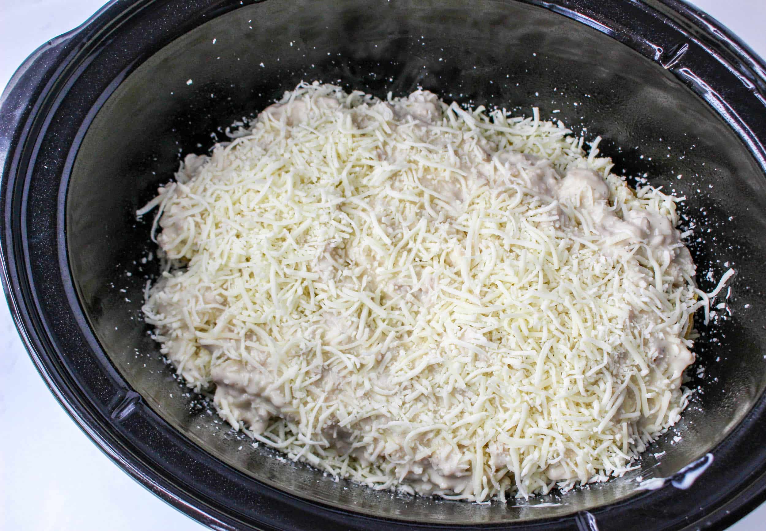 cheese on top of a layre on noodles in a crock pot