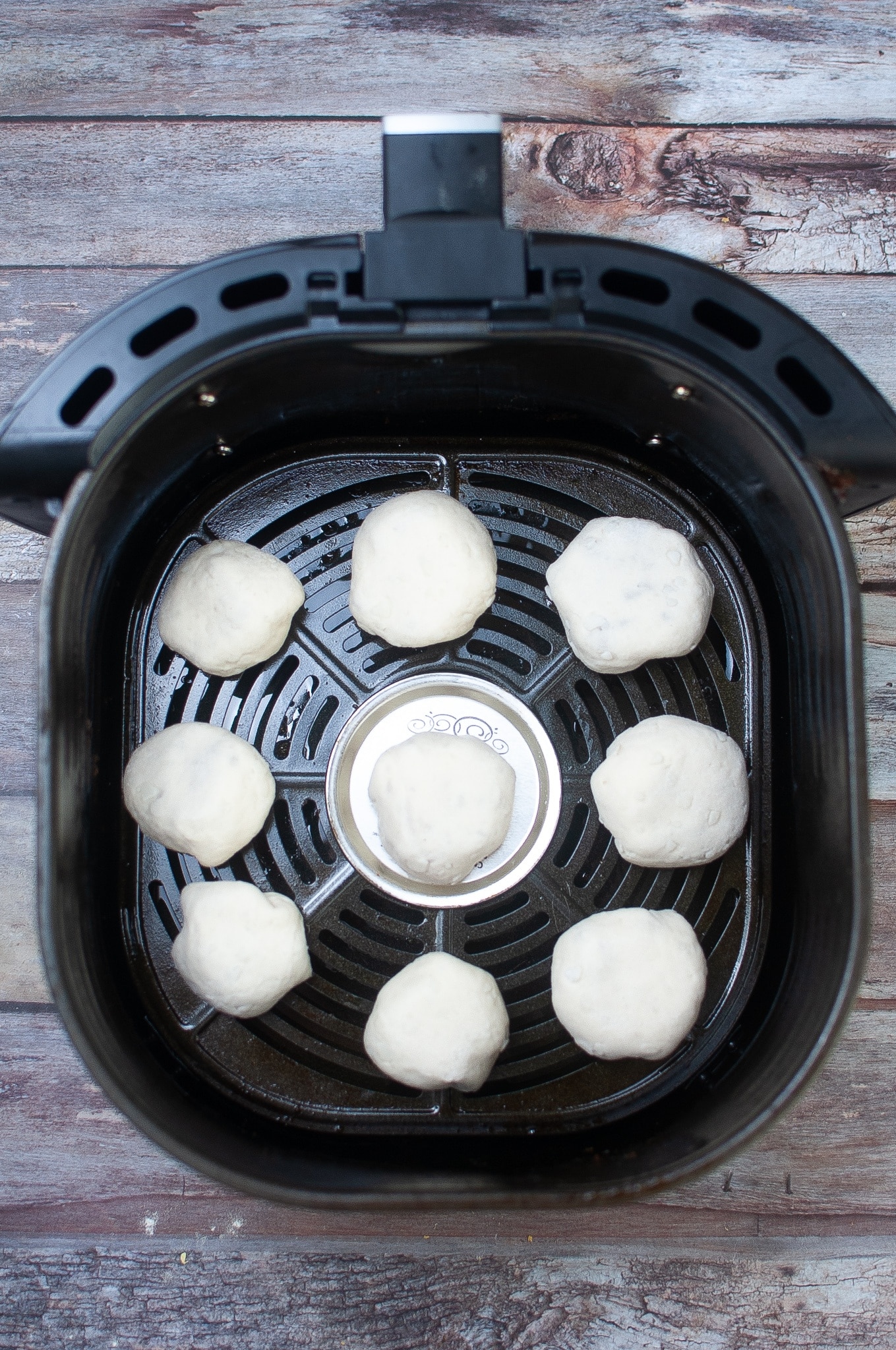 stuffed biscuits spaced out in the air fryer basket