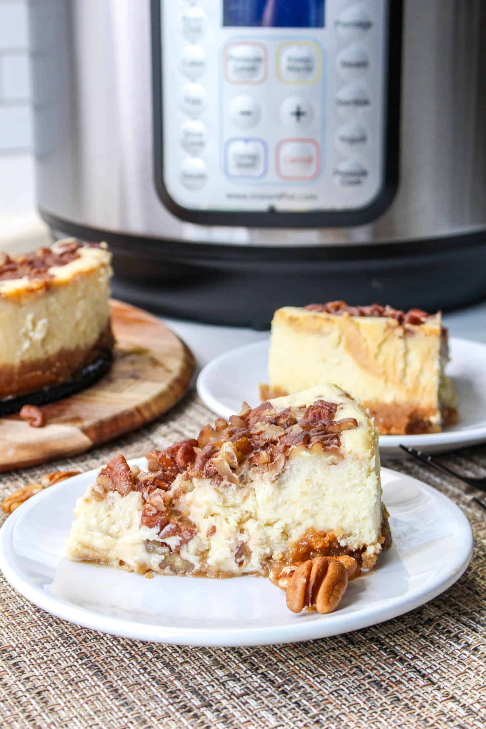 slice of instant pot pecan pie cheesecake on a white plate