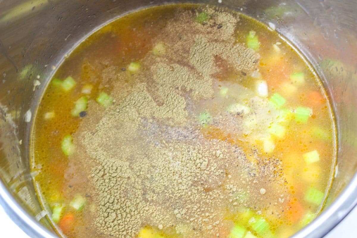 borth, seasonings and vegetables in a pot