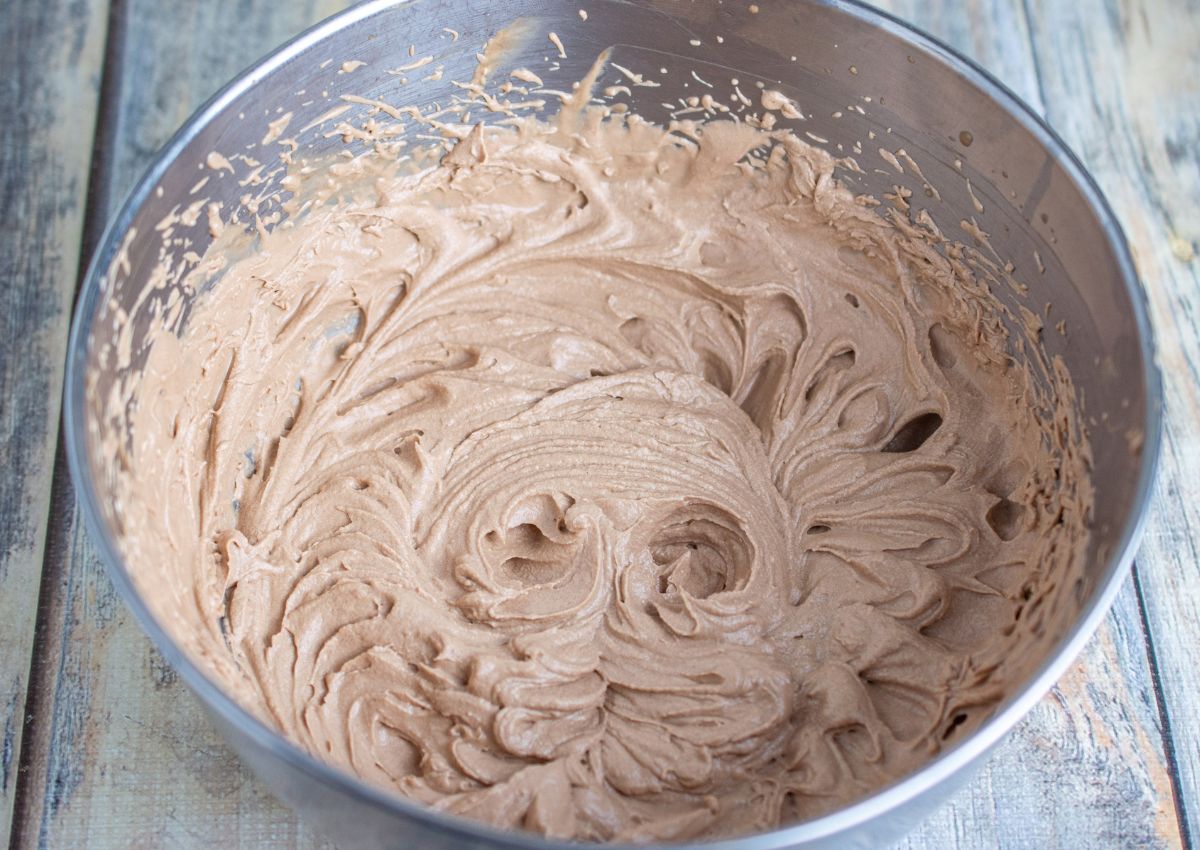 whipped chocolate in a stainless steel mixing bowl