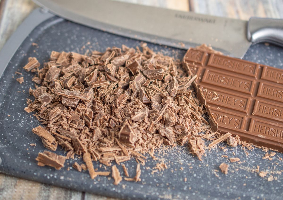 chocolate bar being chopped up on a cutting board