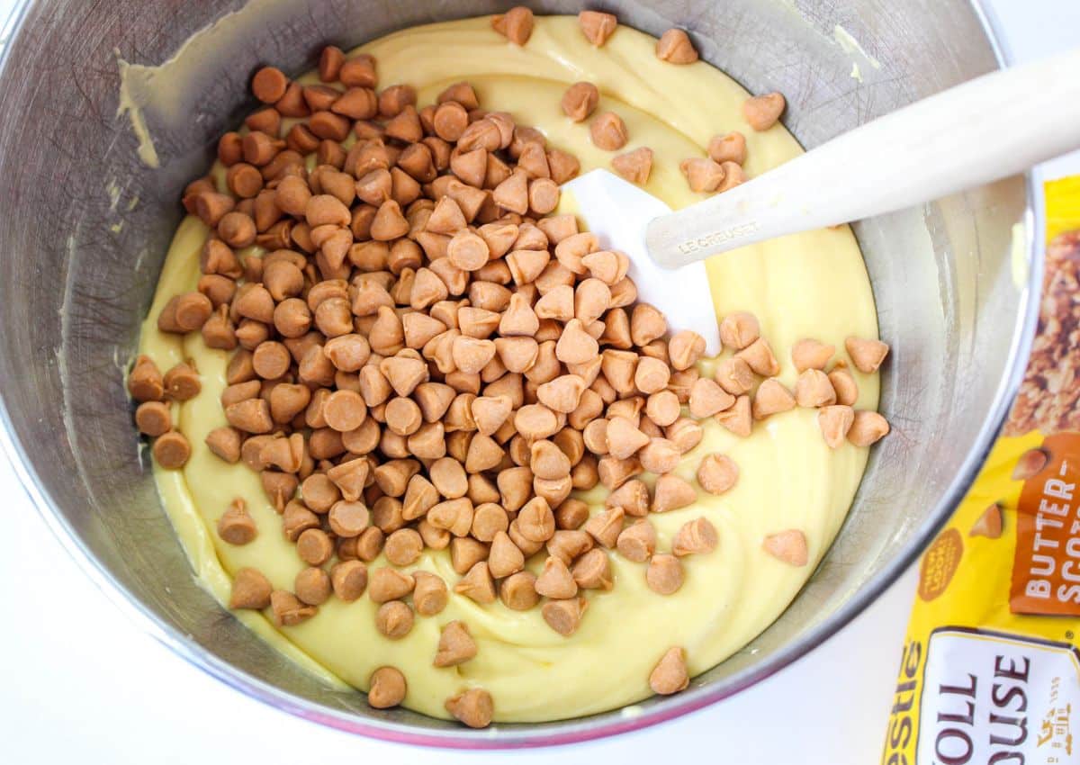 cake batter and chips in a stainless steel mixing bowl