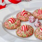 candy cane shortbread cookies on white plte wtih candy cane kisses