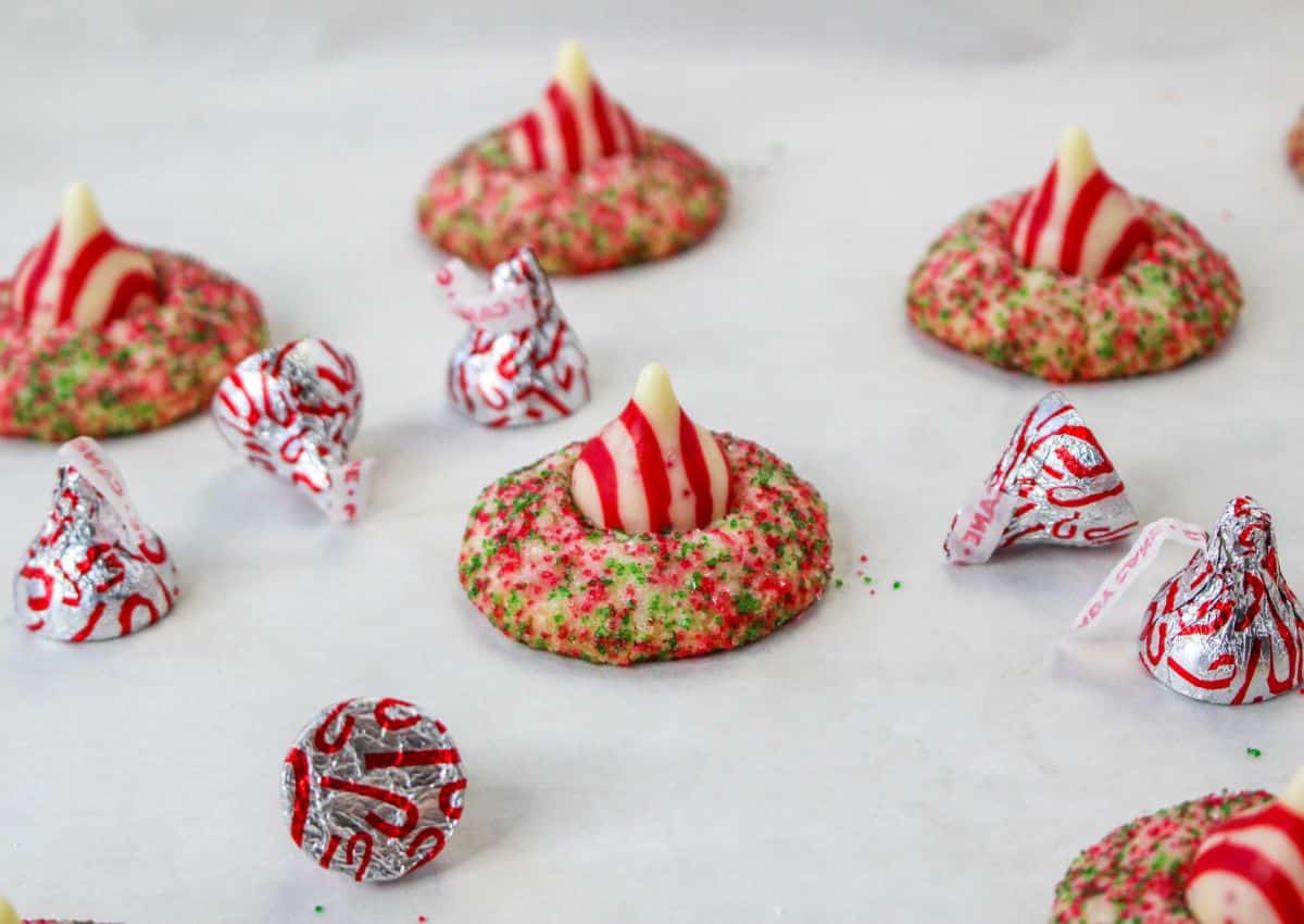 cooked candy cane shortbread cookies on a parchment lined baking sheet