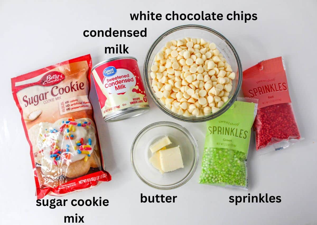 white chocolate chips, condensed milk, sprinkles, sugar cookie mix, and butter on a white background
