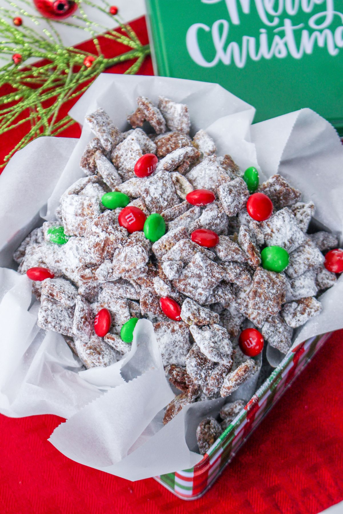 Christmas Muddy Buddies in a red, green, and white tin
