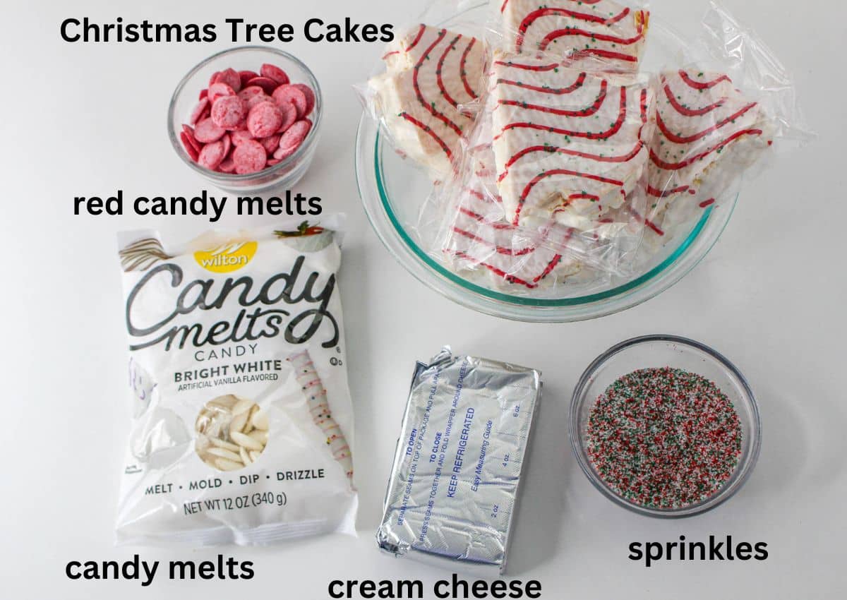 christmas tree cakes, red candy melts, white candy melts, cream cheese, and sprinkles on a white background