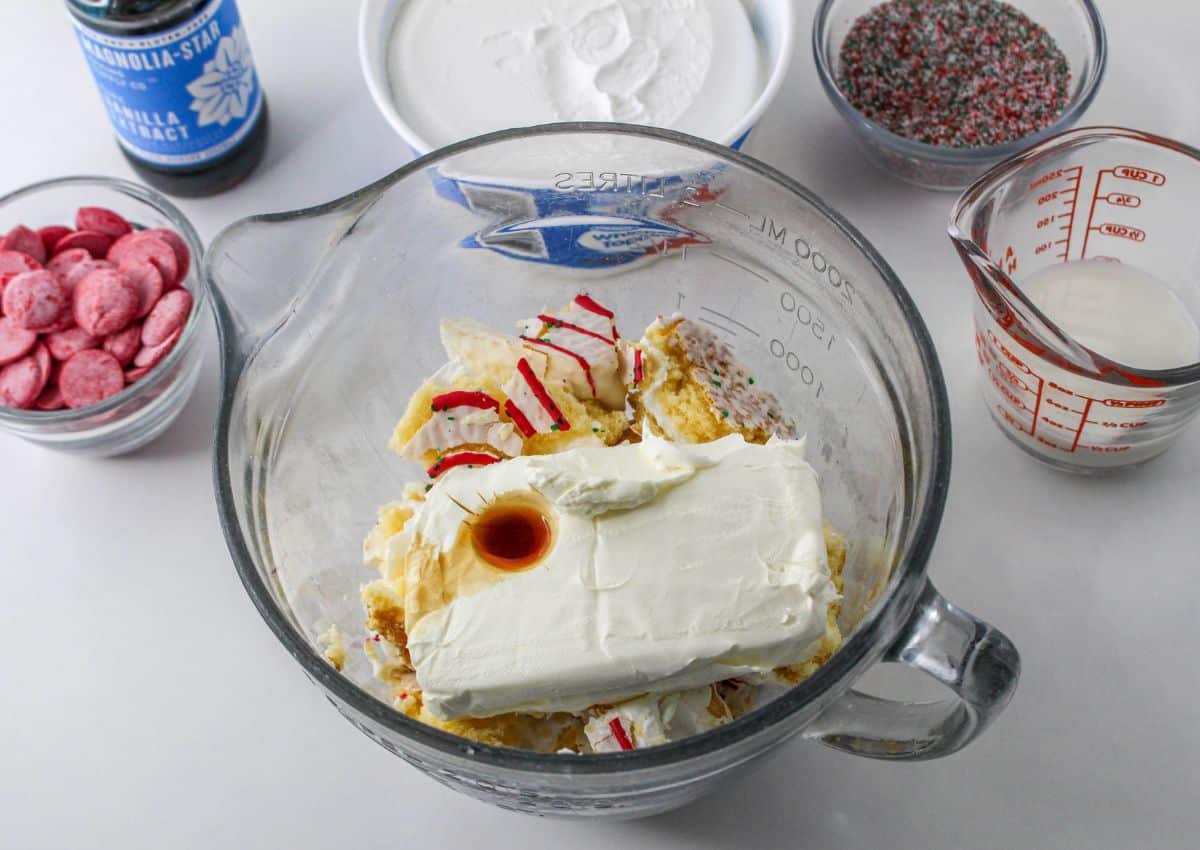 cakes, cream cheese and vanilla in a glass mixing bowl