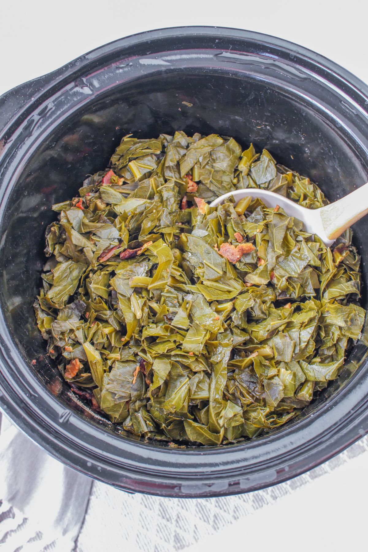 slow cooker filled with collard greens