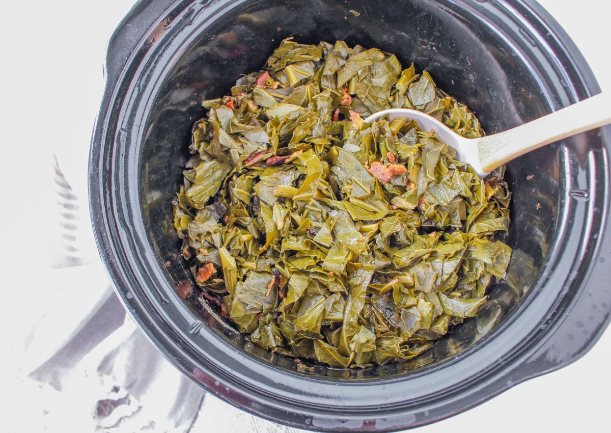 slow cooker filled with collard greens