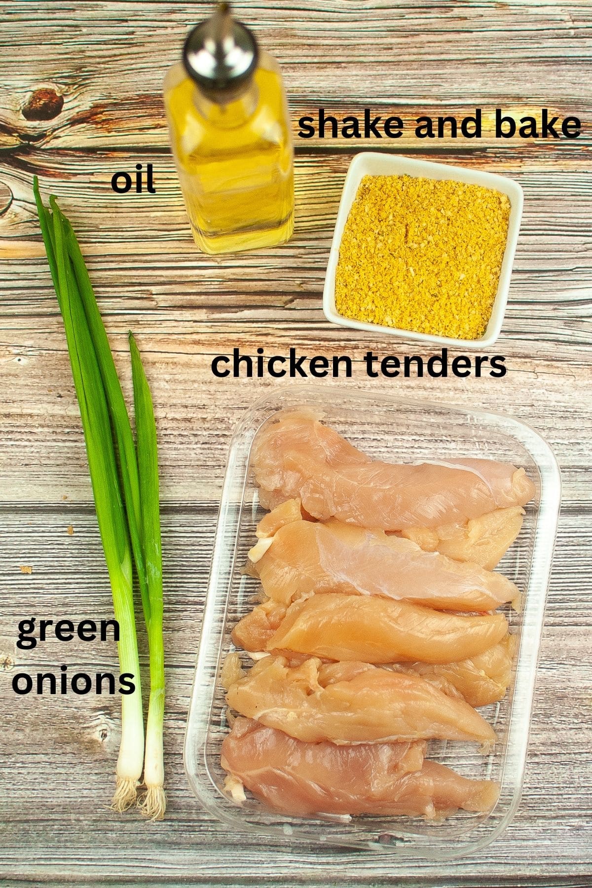chicken tenders, shake and bake, oil and green onions on a wooden background