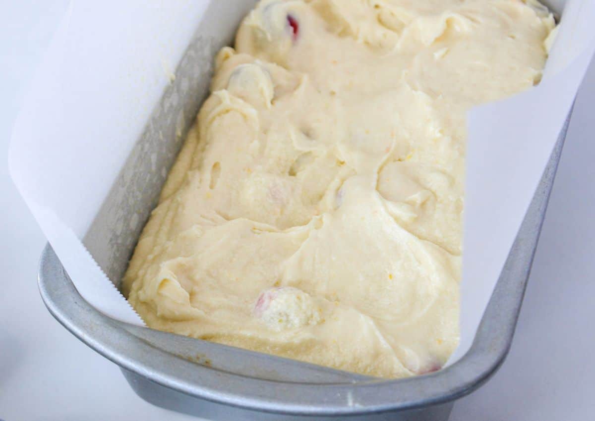 batter in a parchment-lined baking loaf pan