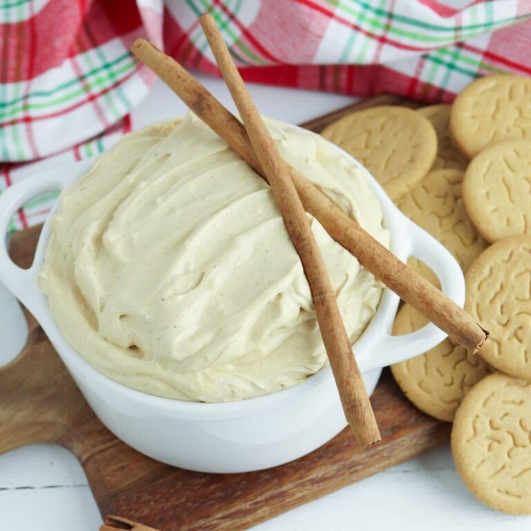 white bowl filled with gingerbread dip topped with cinnamon sticks