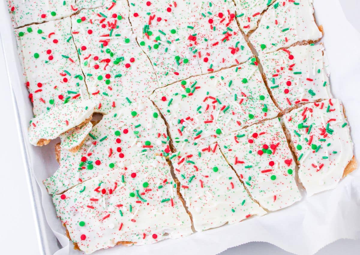 broken white chocolate christmas crack on a parchment lined baking sheet